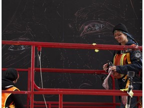 Artists Layla Folkmann (left) and Lacey Jane use chalk as they works construct Pillars of the Community, artwork which will involve artists through Boyle Street Community Services, on the LRT vent outside of the northeast corner of Rogers Place on Sept.r 22, 2016.