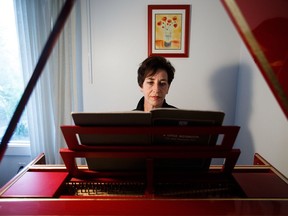 Beth Turnbull plays the harpsichord built by her late husband, Chris Kubash. The harpsichord is part of a performance called Mysterious Barricades being held on Sept. 10 to coincide with World Suicide Awareness Day.