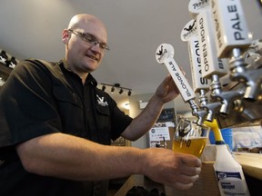 Charlie Bredo of Troubled Monk Brewery pours a pint of golden ale at the brewery in Red Deer, Alberta on Monday, August 29, 2016.