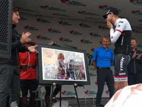 Canadian cyclist Ryder Hesjedal reacts during a presentation of a special framed image in recognition of one of his last competitive rides. The presentation was made at the end of the final stage of the 2016 Tour of Alberta in Edmonton Monday, Sept. 5, 2016.