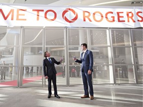 Edmonton Oilers owner Daryl Katz (left) and Edmonton Mayor Don Iveson pull the banner down during the opening ceremony at Rogers Place Arena, the new home of the Edmonton Oilers on Sept. 8, 2016.