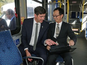Edmonton Mayor Don Iveson and Dr. Zhi-Jun (Tony) Qiu, assistant professor of transportation Engineering at the University of Alberta, discuss the Active-Aurora project, currently being tested on Edmonton roads, on Sept. 16, 2016.