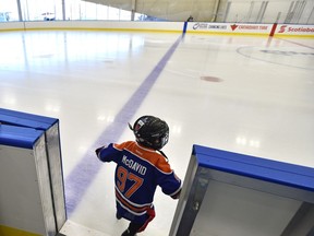 A tiny McDavid steps onto the ice after the grand opening of the Downtown Community Arena attached to Rogers Place in Edmonton, Sunday, September 25, 2016.