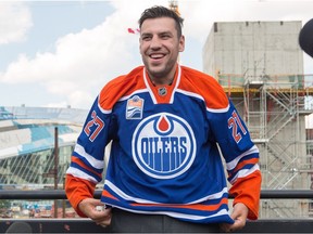 Milan Lucic, the newest Edmonton Oiler, puts on his new jersey number during a press conference in Edmonton July 1, 2016.