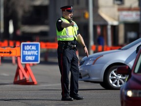 A Journal letter writer says it would have been nice to see police helping out at intersections like this officer, pictured in a 2011 photo at Whyte Avenue and 99 Street, when traffic lights were down during the Wednesday morning commute.