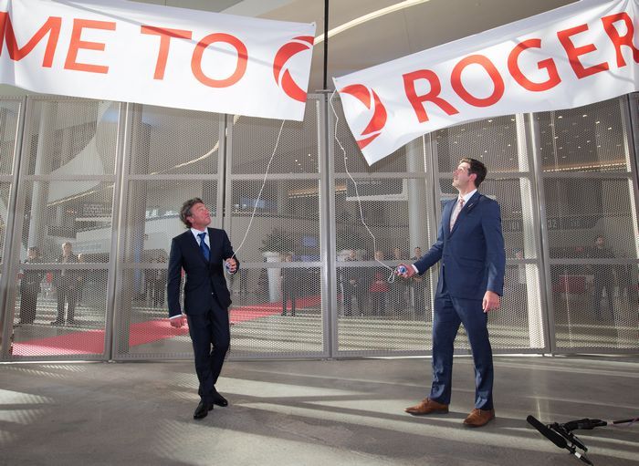 Oilers owner Daryl Katz and then-mayor Don Iveson pull the banner down during the grand opening of Rogers Place in Edmonton on Sept. 8, 2016. The team and the city collaborated on the project with virtually no help from the provincial government.