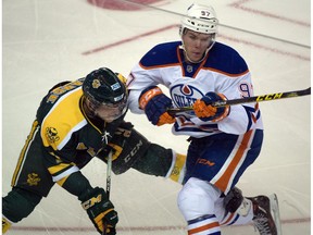 Sawyer Lange (7) and Connor McDavid (97) battlle as the Oilers Rookies win 6-3 in the annual matchup between the Oilers rookies and the University of Alberta Golden Bears in Edmonton on September 16, 2015.