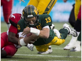 Edmonton Eskimos quarterback Mike Reilly (13) dives for a first down against the Calgary Stampeders on Saturday, September 10, 2016 in Edmonton.