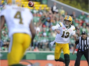 Edmonton Eskimos quarterback Mike Reilly, centre, throws a pass to Adarius Bowman during first half CFL action against the Saskatchewan Roughriders, in Regina on Sunday, September 18, 2016.