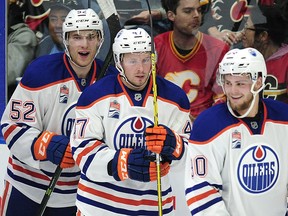 Edmonton Oilers' P{atrick Russell (52), Joey Benik (47) and Aaron Irving (9) celebrate a goal against the Calgary Flames during third period 2016 NHL Young Stars Classic action at the South Okanagan Events Centre in Penticton, B.C., on Sept. 17, 2016.