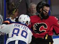 Calgary Flames' Hunter Smith (71) is slammed to the boards by Edmonton Oilers' Kayle Doetzel (89) during first period 2016 NHL Young Stars Classic action at the South Okanagan Events Centre in Penticton, BC., September 17, 2016.