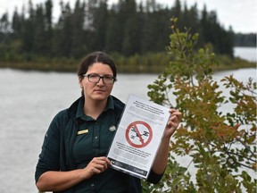 Janelle Lane, Elk Island National Park, communications officer, shows a sign on Sept. 12, 2016 informing national park visitors that drones are banned to protect the sensitive environment.