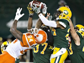 B.C. Lions' Emmanuel Arceneaux (84) tries to get the pass as Edmonton Eskimos Brandyn Thompson (24) makes the interception during second half CFL action in Edmonton on Sept. 23, 2016.