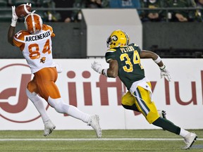 B.C. Lions' Emmanuel Arceneaux (84) makes the catch as Edmonton Eskimos Garry Peters (34) gives chase during first half CFL action in Edmonton, Alta., on Friday September 23, 2016.