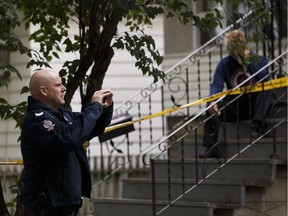 An Edmonton Police Service forensic investigator on Sept. 2, 2016, at 9808 81 Avenue. A burned body was found outside the home overnight.