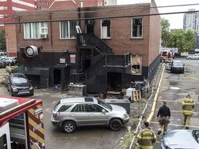 Fire investigators were looking over the scene of an early morning fire in the rear of a building near 100 Avenue and 105 street on Sept. 2, 2016.