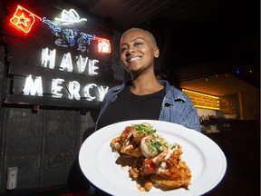 Diana Rubayiza holds a plate of Fried Green Tomatoes and Shrimp at Have Mercy, 8232 Gateway Boulevard, in Edmonton on Wednesday, Aug. 24, 2016.