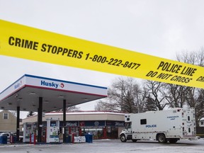 Homicide detectives investigate at a Mac's convenience store where the clerk was shot dead.