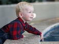 Isaac Tymchuk, 2, plays near a fountain at the Mazankowski Alberta Heart Institute in Edmonton, Alta., on Monday, Sept. 19, 2016. The young toddler from Calgary became the first neonatal cardiac hybrid surgery patient in Western Canada almost two years ago.