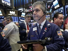 Trader John Panin, centre, works on the floor of the New York Stock Exchange, Tuesday, Sept. 6, 2016. U.S. stocks indexes are mostly higher in early trading as traders look over the details of several corporate deals.