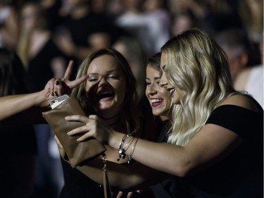 Fans take a photo as Keith Urban performs at Rogers Place in Edmonton, Alberta on Friday, September 16, 2016.