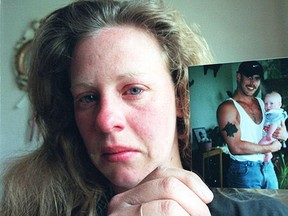April Milliken in 1997 with a photograph of her brother Jim Milliken holding his son.