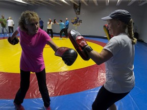 Marie Bohaychuk works with instructor Margaret Orr during the Fighting Back program for Parkinson's class at Millennium Place on Wednesday, August 31, 2016 in Sherwood Park.