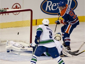 Rookie Edmonton Oilers centre Ryan Nugent-Hopkins scores on Vancouver Canucks Roberto Luongo during NHL action at Rexall Place on Oct. 15 2011.