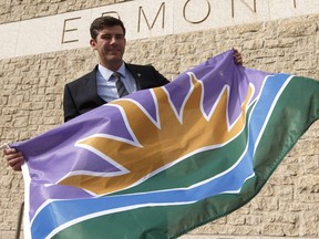 Mayor Don Iveson with Ryan McCourt's take on a new Edmonton flag on Thursday, Sept. 22, 2016. Iveson has now dropped the idea of using this as the new city flag.