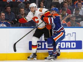 EDMONTON, AB - SEPTEMBER 26: Markus Niemelainen #80 of the Edmonton Oilers skates against Jamie Devane #65 of the Calgary Flames in an NHL preseason game on September 26, 2016 at Rogers Place in Edmonton, Alberta, Canada.