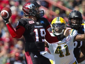 Edmonton Eskimos' Odell Willis, right, closes in on Calgary Stampeders quarterback Bo Levi Mitchell during first half CFL football action in Calgary, Monday, Sept. 5, 2016.THE CANADIAN PRESS/Jeff McIntosh ORG XMIT: JMC105