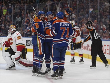 The Edmonton Oilers' Mitchell Moroz (53), Iiro Pakarinen (26), and Kyle Platzer (73) celebrate Pakarinen's goal against the Calgary Flames during first period pre-season NHL action at Rogers Place, in Edmonton on Monday Sept. 26, 2016.