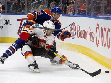 The Edmonton Oilers' Markus Niemelainen (80) battles the Calgary Flames' Andrew Mangiapane (88) during second period pre-season NHL action at Rogers Place, in Edmonton on Monday Sept. 26, 2016.