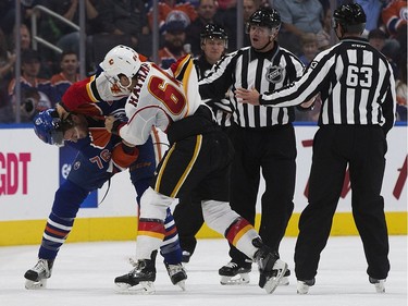 The Edmonton Oilers' Ben Betker (74) fights the Calgary Flames' Garnet Hathaway (64) during second period pre-season NHL action at Rogers Place, in Edmonton on Monday Sept. 26, 2016.