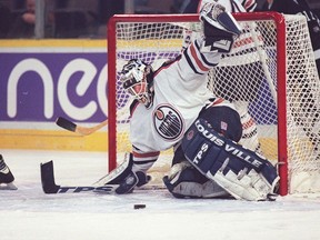 Curtis Joseph stops a Vancouver Canucks shot during the Edmonton Oilers' 2-0 win at Edmonton Coliseum on Oct. 6, 1996.