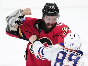 Calgary Flames' Hunter Smith (71) fights with Edmonton Oilers' Kayle Doetzel (89) during third period 2016 NHL Young Stars Classic action at the South Okanagan Events Centre in Penticton, BC., September 17, 2016.