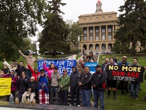 People gather at the Alberta legislature to protest the building of the Site C dam in northeastern British Columbia.