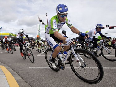 Riders in the peloton stay tight to the corner as they race in stage 3 of the Tour of Alberta in Drayton Valley, Alta., on Sept. 3, 2016.