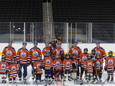 Members of the Edmonton Oilers and players from the Edmonton Minor Hockey Association pose for a photo as they take the first skate on the ice at Rogers Place, in Edmonton on Thursday Sept. 1, 2016. Photo by David Bloom