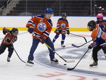 The Edmonton Oilers' Ryan Nugent-Hopkins and players from the Edmonton Minor Hockey Association take the first skate on the ice at Rogers Place, in Edmonton on Thursday Sept. 1, 2016. Photo by David Bloom