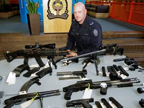 Sgt. Grant Jongejan of the Edmonton Police Service bomb unit at police headquarters on Friday, Sept. 9, 2016 with some of the weapons confiscated during a search of a Mill Woods garage.