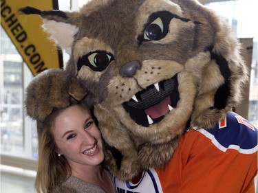 Kaitlyn Wietzel meets the Edmonton Oiler's new mascot Hunter the Canadian Lynx, in Edmonton on Monday Sept. 26, 2016.
