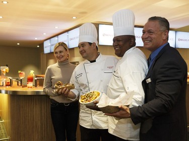 Left to right: Susan Darrington, Chef Johnny Blackerby, Chef O'Brien Tingling and Eric Bayne hold new food options as the Rogers Place Food and Beverage Team unveils new food options during a media conference.