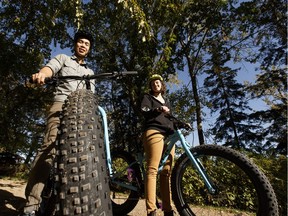 Elly Knight (right) and Dan Yip, University of Alberta PhD students in Biological Sciences, pose for a photo, in Edmonton, Alberta on Thursday, September 22, 2016, with fat bikes used in their studies of the common nighthawk near Fort McMurray.