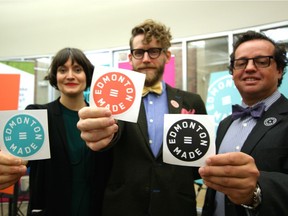 Carmen Douville, project facilitator for Edmonton Made, Duchess Bake Shop co-owner Garner Beggs and Coun. Michael Oshry, show the badges that will identify Edmonton-made businesses.