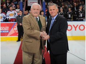 WHL commissioner Ron Robison, right, presents Edmonton Oil Kings scout Bob McGill with the WHL Distinguished Service Award on March 17, 2016 in Edmonton. McGill a longtime scout passed away this past weekend.