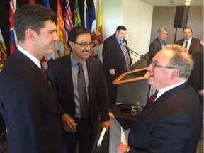 (left-right) Mayor Don Iveson, federal Infrastructure Minister Amarjeet Sohi and provincial Infrastructure Minister Brian Mason (all former Edmonton city councillors) talk after an infrastructure meeting in Edmonton Wednesday.