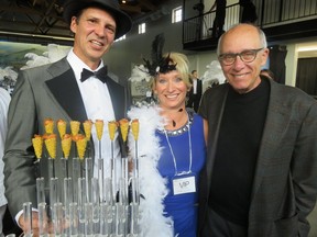 Lyndon Decore, board chair of the Fort Edmonton Foundation board chair, offers tasty finger food to foundation executive director Janet Tryhuba and newly appointed Honorary Fort Factor Stephen Mandel at the Fort's gala raising funds for expansion.