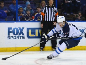 ST. LOUIS, MO - FEBRUARY 8: Jacob Trouba #8 of the Winnipeg Jets looks to take a shot on goal against the St. Louis Blues at the Scottrade Center on February 8, 2014 in St. Louis, Missouri.