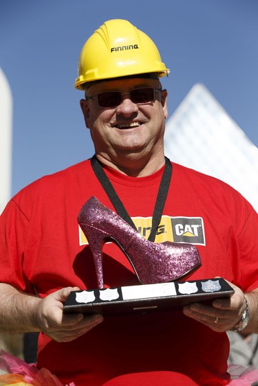 Best individual fundraiser Al Madge, who walks in memory of his mother, shows his pink shoe trophy for raising $5,912 during YWCA Edmonton's Walk A Mile In Her Shoes on September 21, 2016. Over $200,000 was raised for YWCA violence prevention and recovery programs.